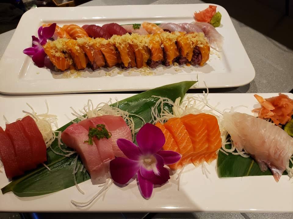 Beautifully decorated pieces of sushi on white plates at Katana Sushi in Midlothian, Virginia. Purple flowers on plate. 