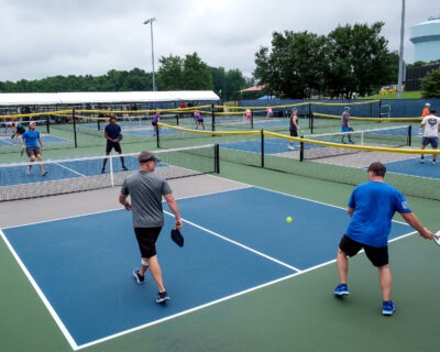 men playing pickleball on blue courts